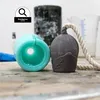 A close-up of a silicone mold and a cast object with a rope attached, with other crafting supplies in the background. Produktbild-Vorschau