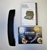 A black grill accessory and two instruction manuals for a George Foreman grill are laid out on a light gray surface. Podgląd zdjęcia produktu