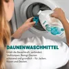 A person is pouring laundry detergent into a washing machine. Produktbild-Vorschau