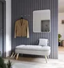 A hallway with a mirror, a jacket on a hook, and a bench with a handbag and shoes. Produktbild-Vorschau