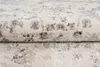 A close-up view of a folded rug with a distressed pattern. Náhled obrázku produktu