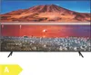 A television displaying a landscape image with a flamingo in the foreground, set on a stand. Produktbild-Vorschau