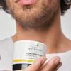 A person is holding a jar of Novexpert Extra Rich Repair Cream. Podgląd zdjęcia produktu