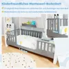 A children's Montessori floor bed with safety rails, shown in a bedroom setting with decorative elements and measurement callouts. Anteprima dell’immagine prodotto