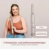 A woman is styling her hair with a hair dryer, and the product's features are highlighted with text overlays. Voir les images du produit