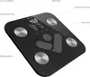A black digital scale with silver electrodes and a digital display, shown from a diagonal angle on a white background with labels pointing to its features. Produktbild-Vorschau
