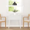 A white dining table with two chairs in a bright room with a window. Náhled obrázku produktu