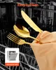 Golden cutlery (knife, spoon, fork) with water droplets inside a dishwasher. Voir les images du produit
