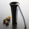 A nutcracker and nuts on a dark wooden surface. Produktbild-Vorschau