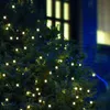 A close-up of a green bush decorated with small, warm white LED lights. Produktbild-Vorschau