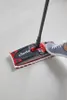 A person is using a Vileda Ultramax mop on a light gray tiled floor. Voir les images du produit
