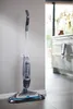 A BISSELL SpinWave Cordless floor washer is shown standing upright against a wall in a modern kitchen. Produktbild-Vorschau