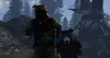 A person in a hazmat suit runs from a bear in a forest with a large structure in the background. Produktbild-Vorschau
