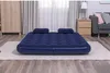 An inflatable mattress with two pillows is set up on a rug in a room with curtains and furniture in the background. Anteprima dell’immagine prodotto