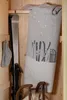 Winter sports equipment and a blanket stored in a wooden closet. Produktbild-Vorschau