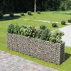 A gabion planter filled with plants in a garden setting. Náhled obrázku produktu