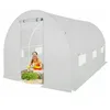A woman is tending to plants inside a white greenhouse.