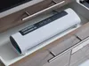 A white vacuum sealer machine is placed inside a drawer. Anteprima dell’immagine prodotto