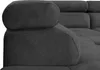 A close-up view of the armrest and headrest of a dark gray sectional sofa. Produktbild-Vorschau
