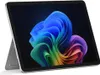 A Microsoft Surface Pro tablet is shown from a slightly angled front view, resting on its kickstand against a dark background. The screen displays a colorful, abstract wallpaper. Náhled obrázku produktu