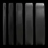 Five black weight plates of varying thickness lined up against a black background. Produktbild-Vorschau