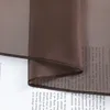A close-up of a sheer brown curtain with text printed on it. Produktbild-Vorschau