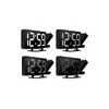 Four identical black digital alarm clocks with a projector are arranged in a 2x2 grid on a white background. Náhled obrázku produktu
