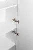 Close-up view of the interior of a white cabinet, showing shelves and hinges. Podgląd zdjęcia produktu