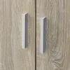 A close-up view of two cabinet doors with handles. Produktbild-Vorschau