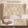 A close-up of a beige upholstered bed headboard with pillows, and inset images showing the texture of the padding and fabric. Produktbild-Vorschau