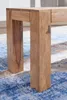 Close-up of the wooden legs of a bench on a patterned rug. Anteprima dell’immagine prodotto