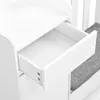 A close-up view of an open drawer on a white furniture piece, with a gray upholstered seat visible to the right. Produktbild-Vorschau
