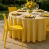 A yellow dining table set for a meal outdoors, with yellow chairs and a yellow tablecloth. Produktbild-Vorschau