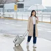 A woman is pulling a transparent suitcase in the rain. Anteprima dell’immagine prodotto