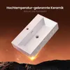 A white ceramic sink with a gold marble pattern is shown at an angle, with a fiery, rocky landscape below and text above. Anteprima dell’immagine prodotto