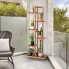 A wooden plant stand with several potted plants on a balcony. Náhled obrázku produktu