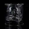 A clear glass tumbler with a skull design molded into the interior wall, set against a black background. Anteprima dell’immagine prodotto