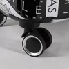 A close-up view of the wheels and lower part of a black and white patterned suitcase. Produktbild-Vorschau