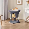 Two cats are relaxing on a multi-level cat tree in a living room setting. Produktbild-Vorschau