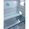 Interior view of an empty refrigerator with glass shelves and interior lighting. Produktbild-Vorschau