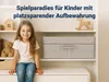 A young girl sits on a shelf in a room with toys and storage boxes. Produktbild-Vorschau