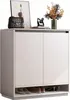 A white shoe cabinet with various decorative items on top and shoes on the bottom shelf. Náhľad obrázku produktu