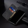 A black leather wallet-style phone case is open, revealing card slots and a phone screen. A watch is visible in the background. Produktbild-Vorschau