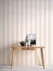 A desk with decorative items against a striped wallpaper. Produktbild-Vorschau