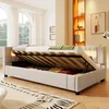 A bedroom scene with a bed that has its storage compartment open, revealing stored items. The bed has LED lighting. Náhled obrázku produktu