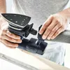 A person is holding a Festool Akku-Deltaschleifer DTSC 400 3,0 I-Plus and attaching a dust collection hose. Voir les images du produit