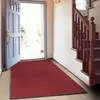 An entryway with an open door and a red mat. Produktbild-Vorschau