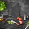 A kitchen scene with cutting boards, vegetables, and a knife. Podgląd zdjęcia produktu