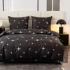 A bed with bedding featuring a star pattern. Anteprima dell’immagine prodotto