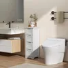 A modern bathroom with a sink, mirror, toilet, and a narrow storage cabinet. Produktbild-Vorschau